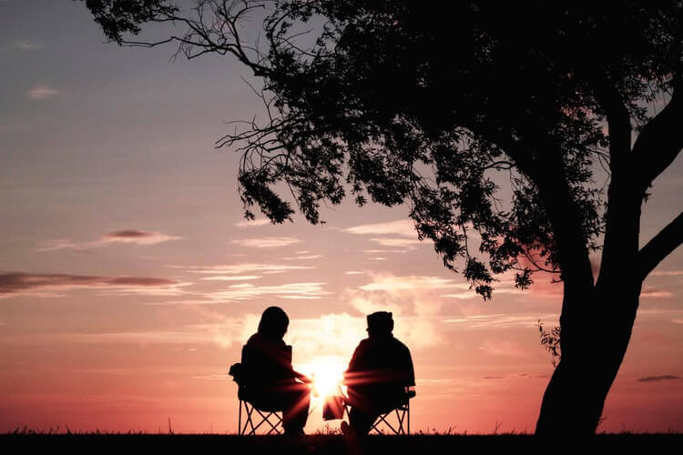 two people talking during the sunset
