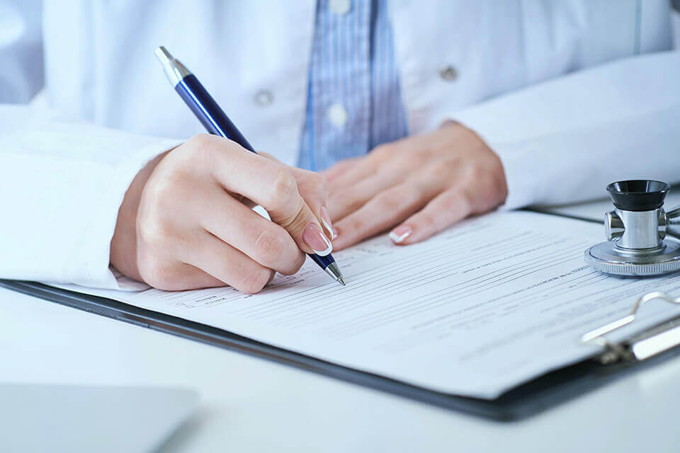 a doctor signing a paper