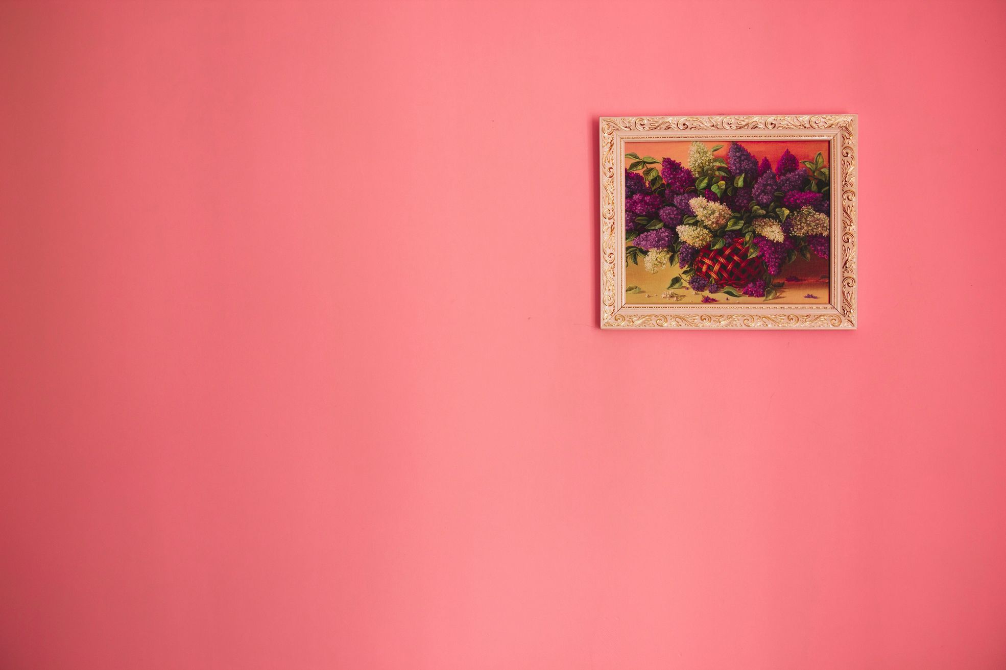 framed flower picture on a pink wall