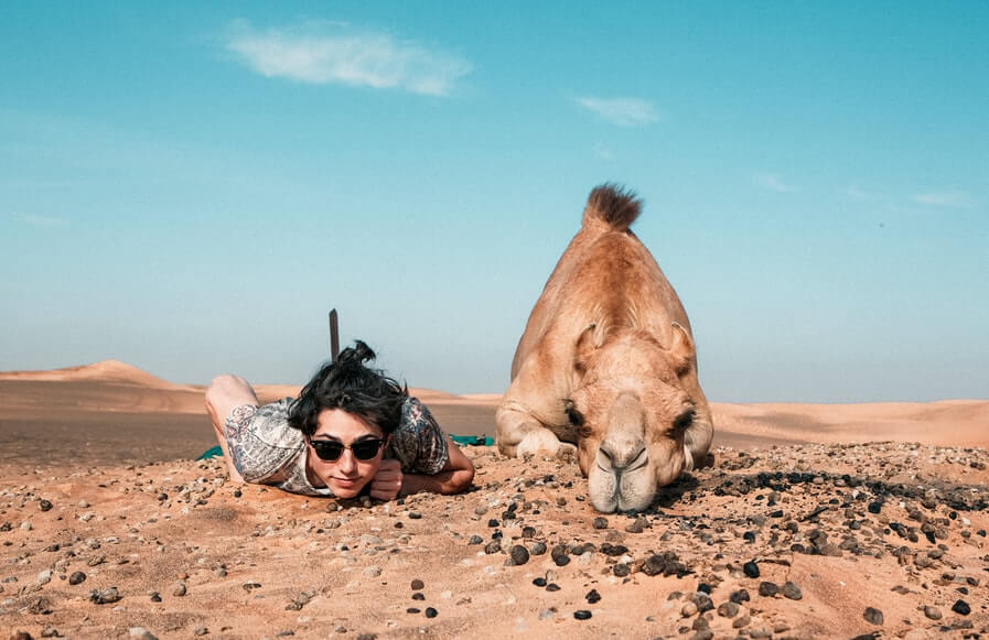 a-man-posing-with-a-camel