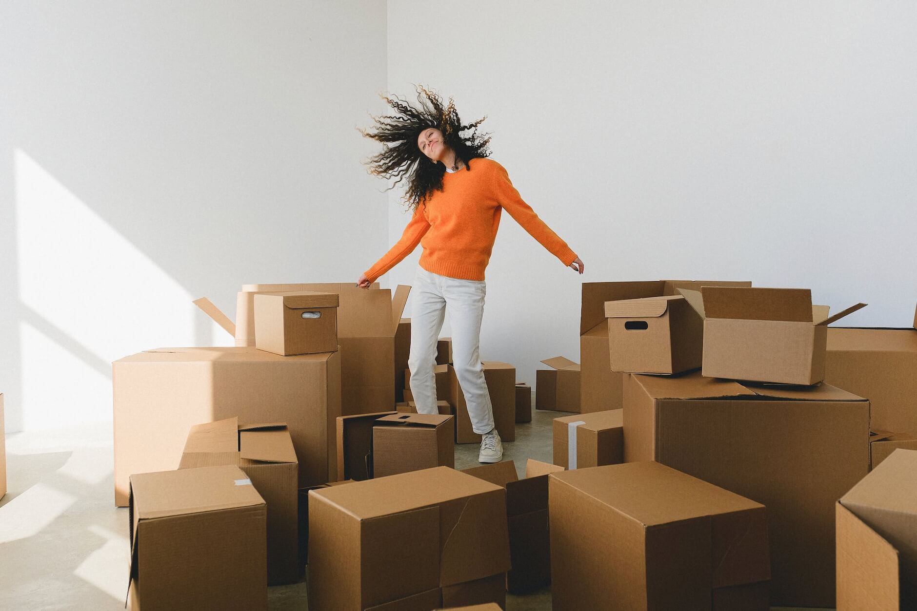 Woman standing surrounded by boxes