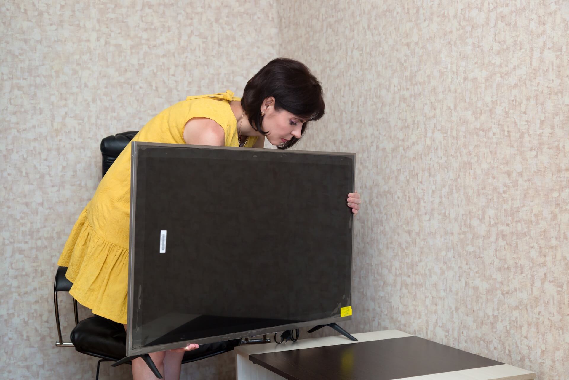 Woman lifting her TV