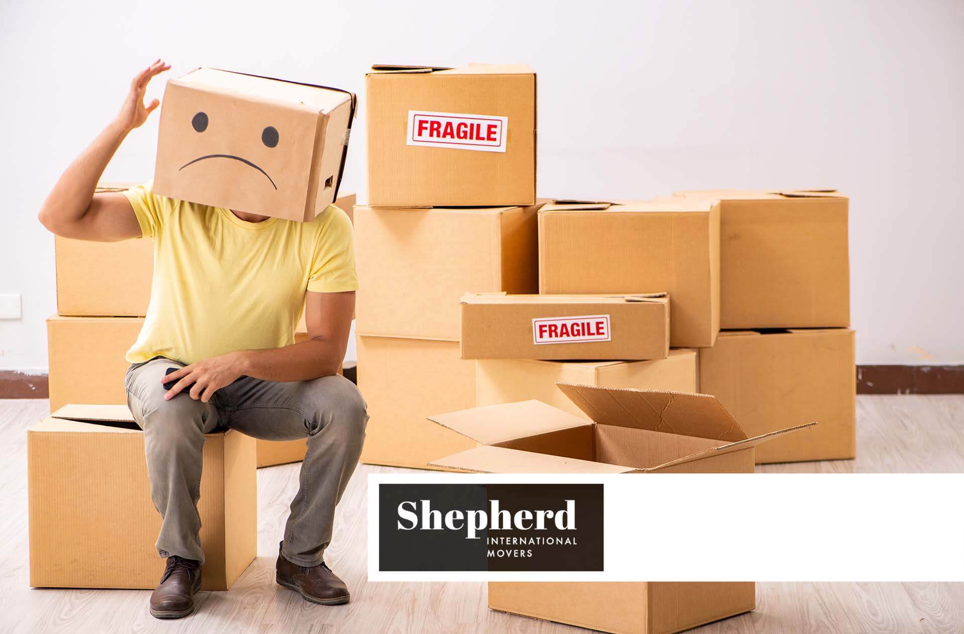 unhappy man with box Shepherd International Movers logo