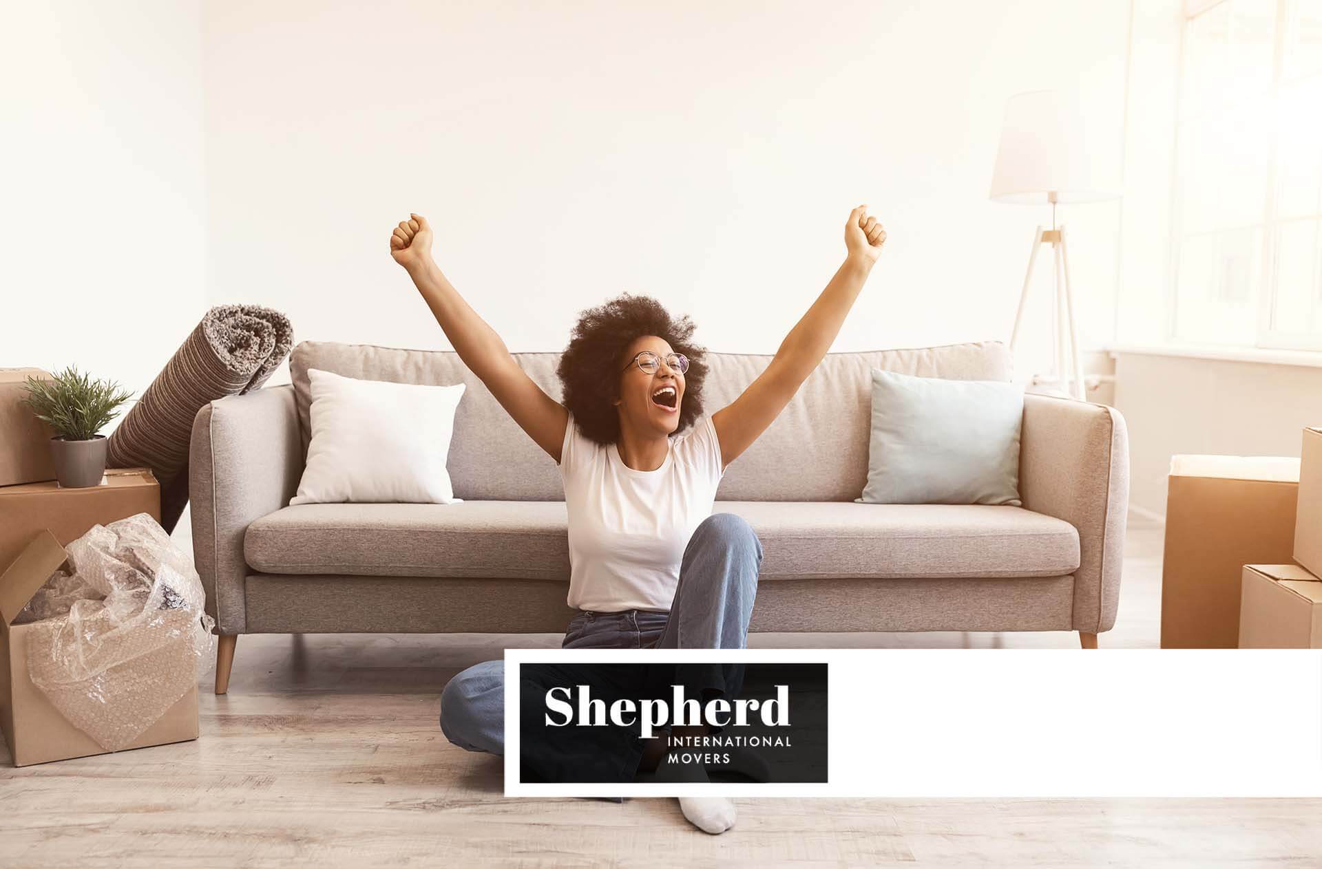 A woman excited about international moving Shepherd International Movers Logo