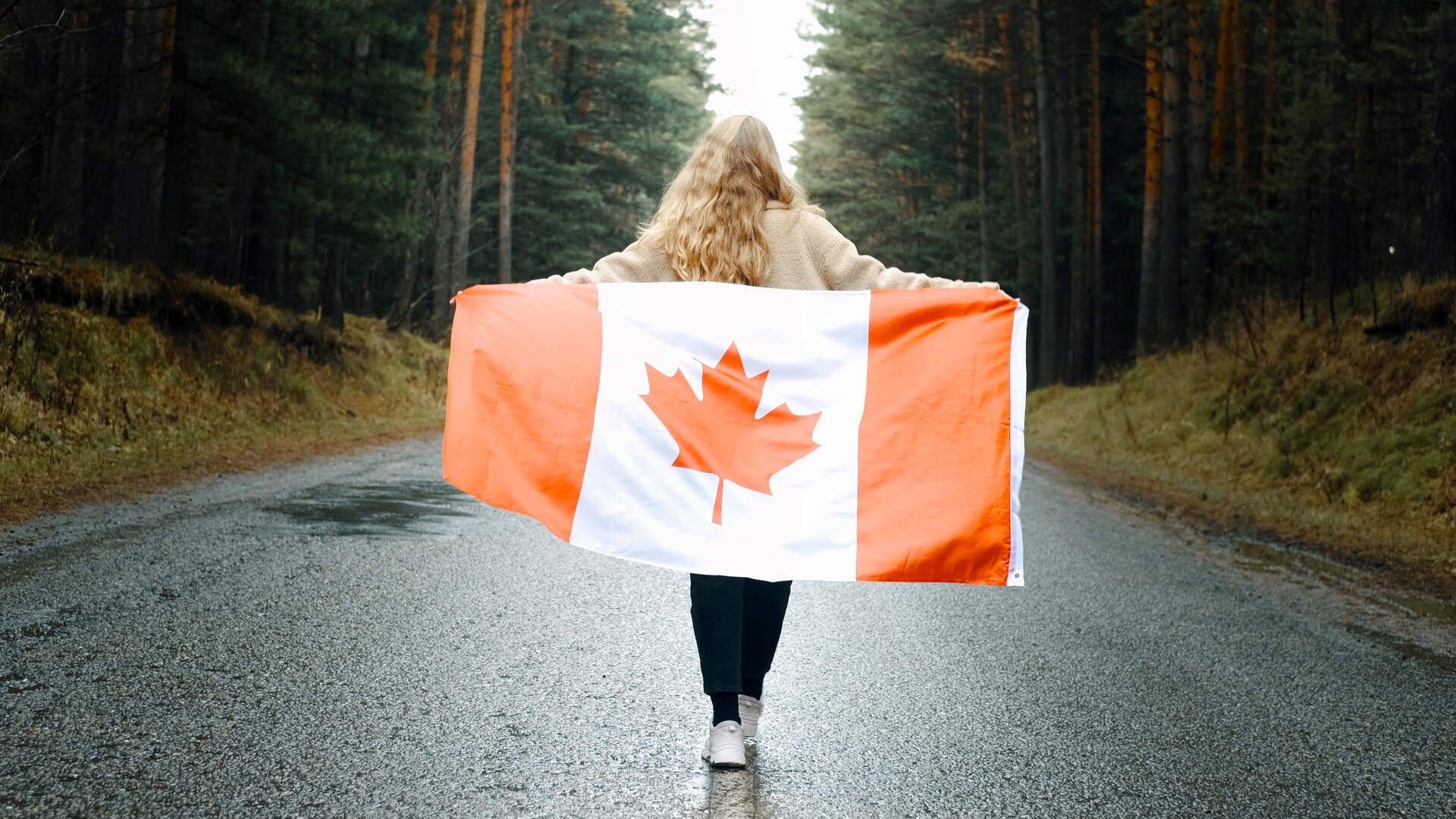 A girl carrying the Canadian flag
