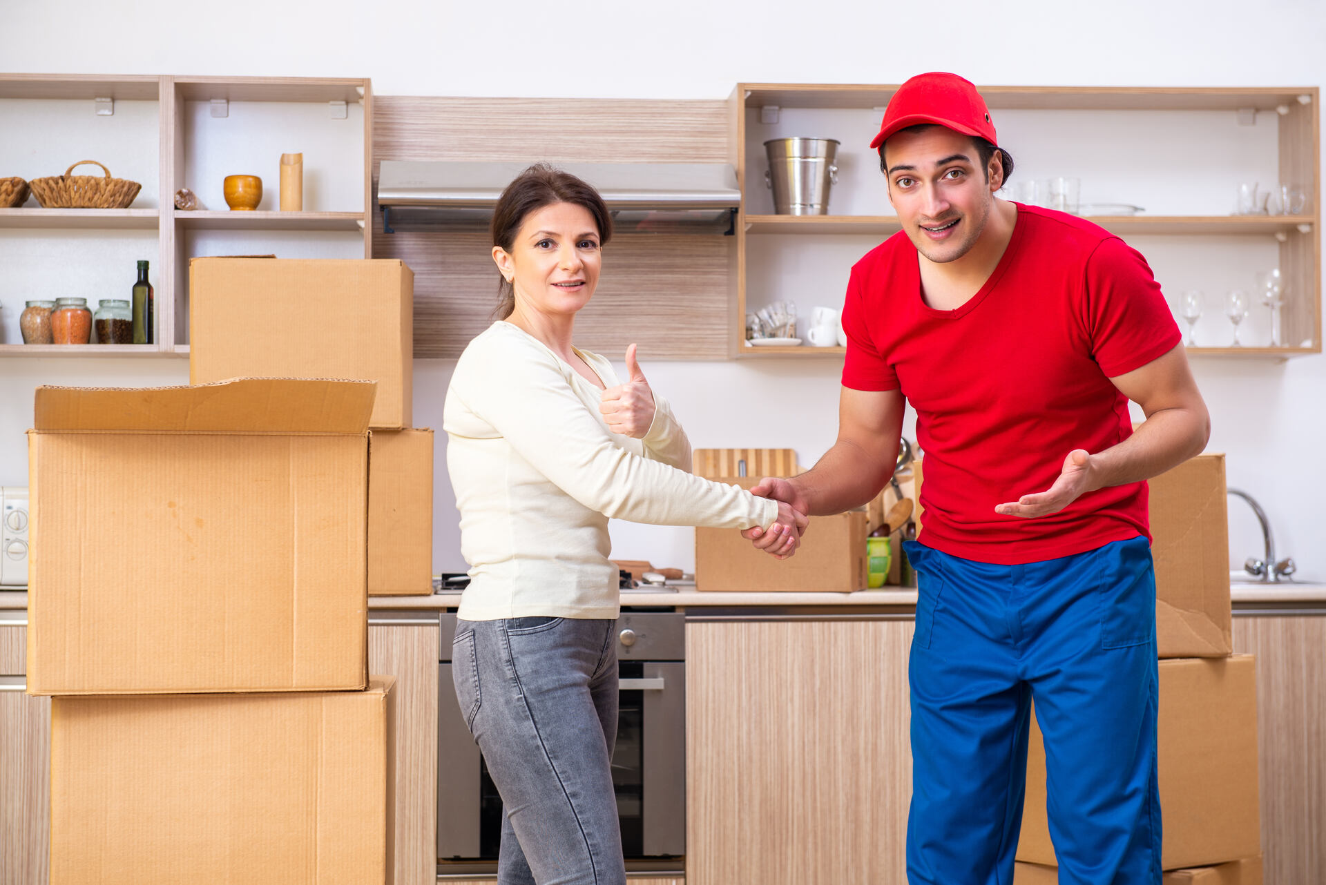 A woman shaking hands with a mover before moving overseas