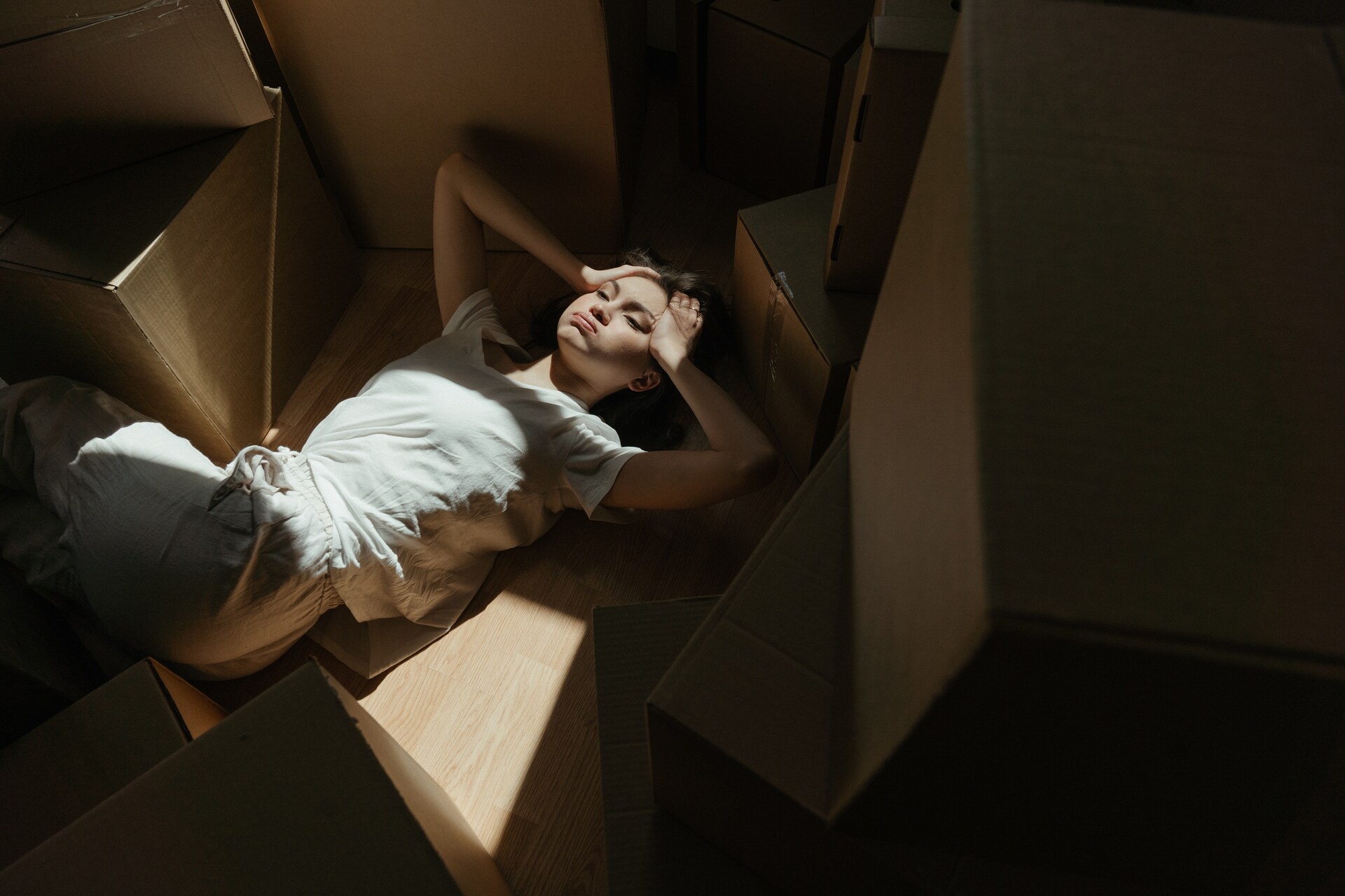 A woman in a white shirt among boxes