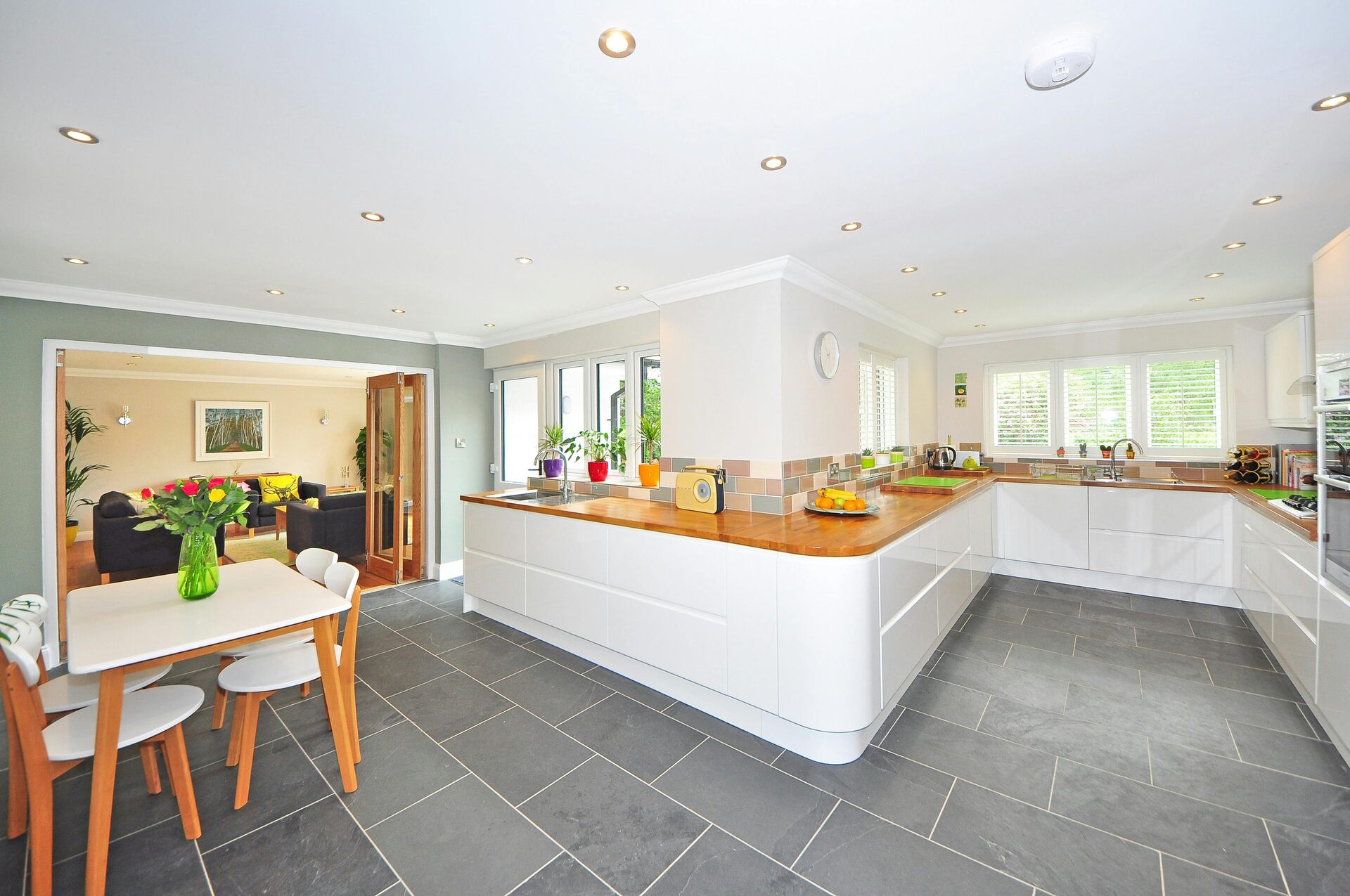 A white kitchen with tile floors