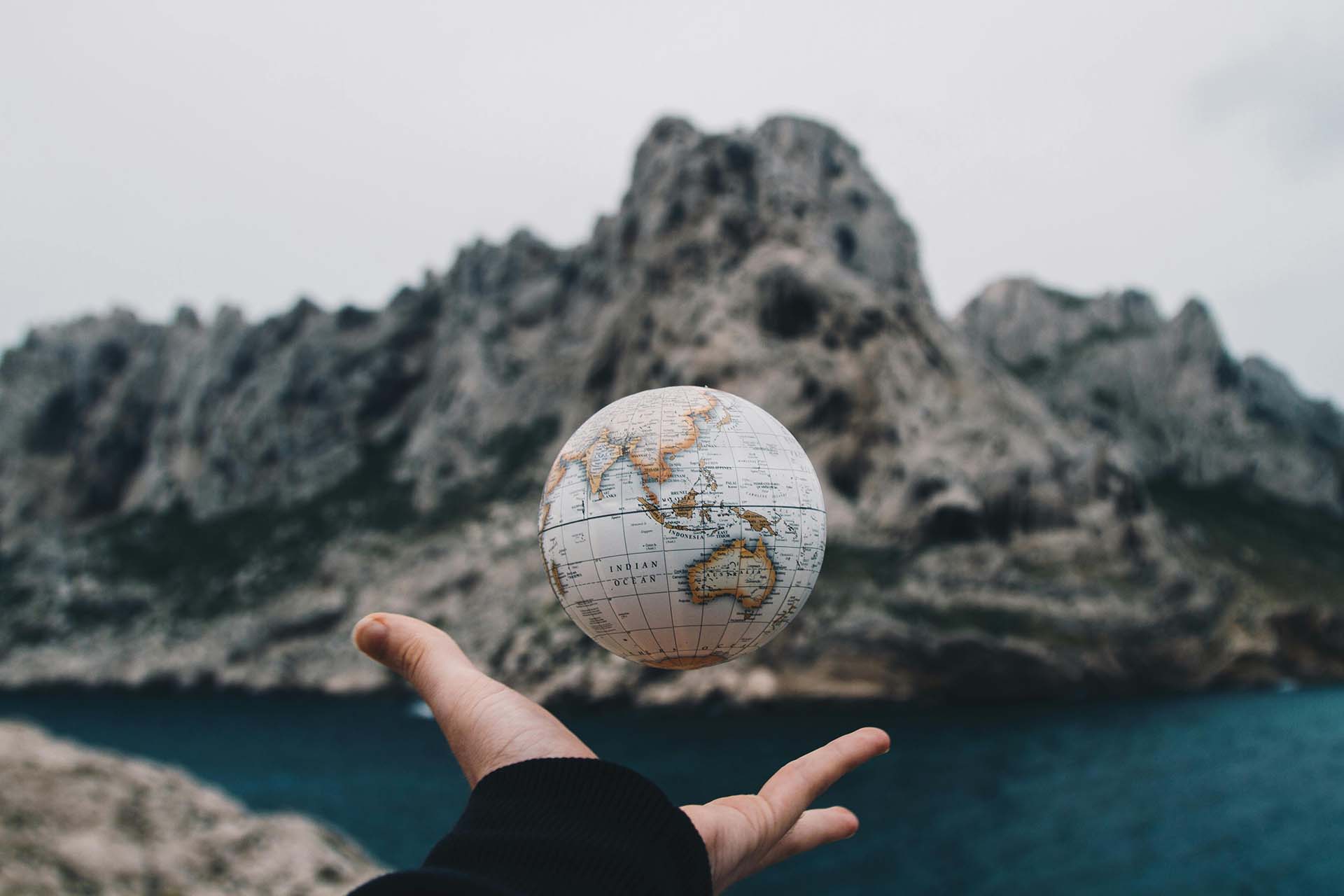 A globe above a hand