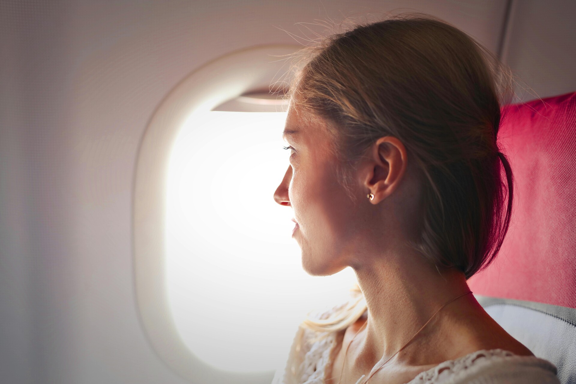 A woman looking out the plane window