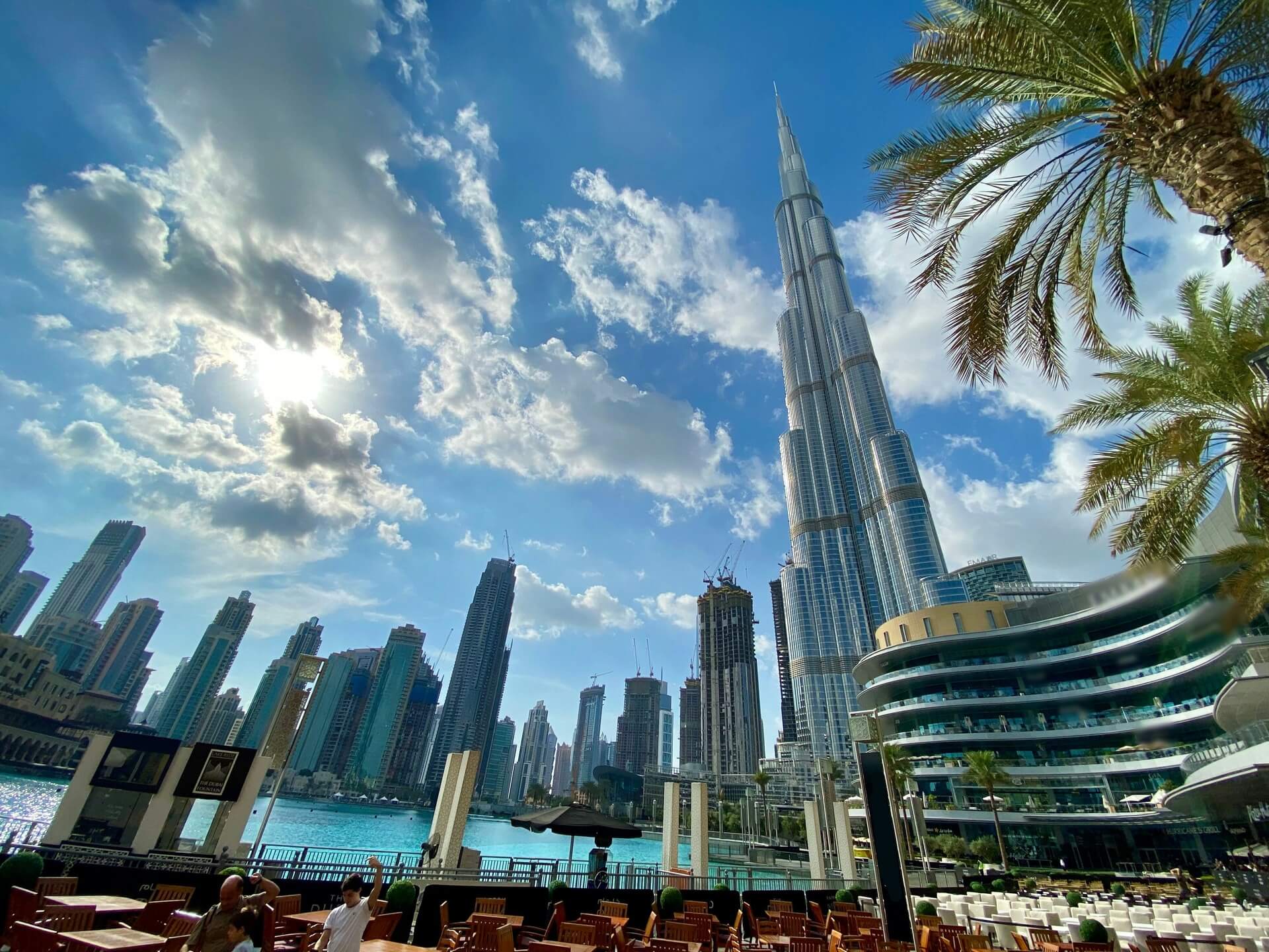 Modern white and gray high-rise skyscrapers situated along the waterfront in Dubai.